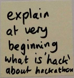 Sticky note with handwritten words: 'explain at very beginning what is "hack" about hackathon'