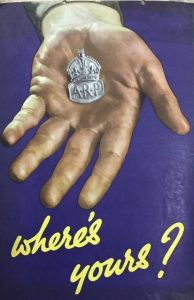 An image of a hand holding a medal, with the words ‘where’s yours’ in a cursive script.